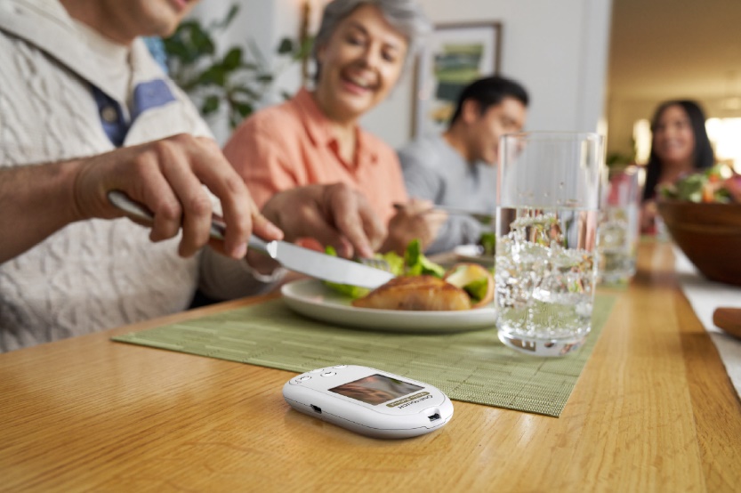 People enjoying a meal with Onetouch® meter next to them